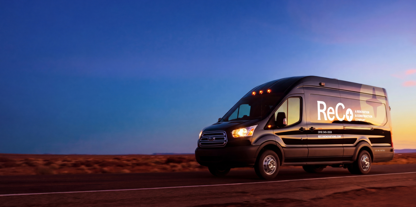 A ReCo van on a road at sunset